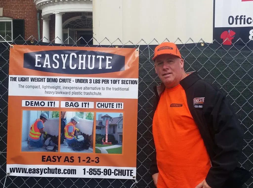 EasyChute co-founder Tim Hogan beside an EasyChute banner on a job site
